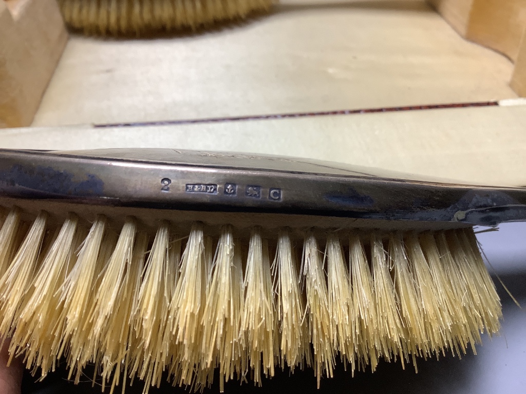 A cased George V silver and tortoiseshell mounted six piece mirror and brush set, maker Harper and Hassett Ltd, Birmingham 1927.